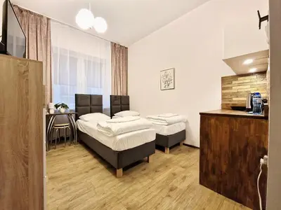 Łóżko lub łóżka w pokoju w obiekcie Hostel Helvetia - Private Rooms in City Center