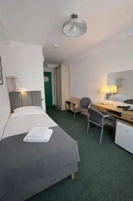 Łóżko lub łóżka w pokoju w obiekcie Hotel Logos
