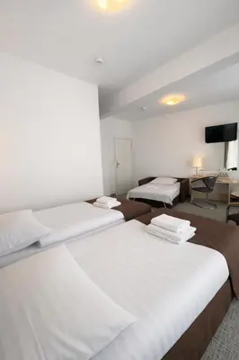 Łóżko lub łóżka w pokoju w obiekcie Hotel Logos