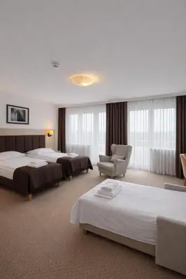 Łóżko lub łóżka w pokoju w obiekcie Hotel Logos