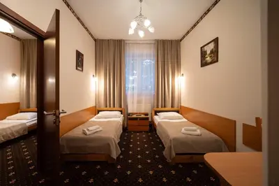 Łóżko lub łóżka w pokoju w obiekcie Hotel Trylogia