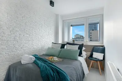 Łóżko lub łóżka w pokoju w obiekcie P&O Apartments Zgoda Pod Orlami