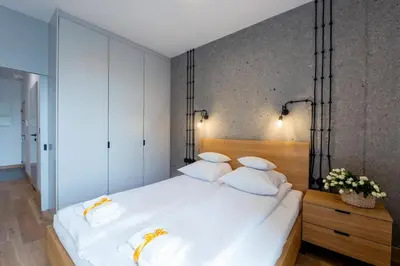 Łóżko lub łóżka w pokoju w obiekcie ApartHotel Kolejowa Apartamenty