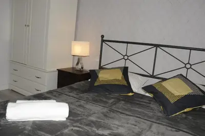 Łóżko lub łóżka w pokoju w obiekcie MiłoTu - Apartament Marszałkowski