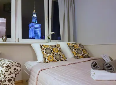 Łóżko lub łóżka w pokoju w obiekcie A.G-Apartamenty Warszawa Centrum