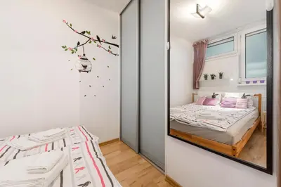 Łóżko lub łóżka w pokoju w obiekcie Apartment Saski Garden Marszalkowska street