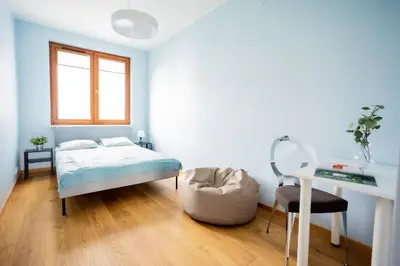 Łóżko lub łóżka w pokoju w obiekcie SuperApart Bobrowiecka 3 - Obok Centrum Olinek
