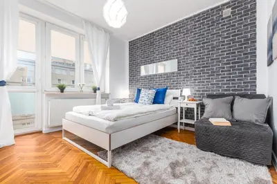 Łóżko lub łóżka w pokoju w obiekcie Apartments Madelaine Warsaw by Noclegi Renters