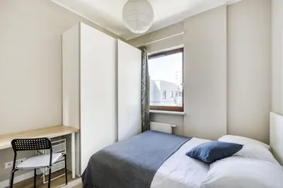 Łóżko lub łóżka w pokoju w obiekcie MG Apartments Giełdowa