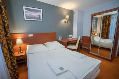 Łóżko lub łóżka w pokoju w obiekcie Hotel Gordon