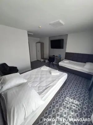 Łóżko lub łóżka w pokoju w obiekcie Hotel Gordon