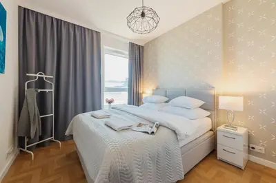 Łóżko lub łóżka w pokoju w obiekcie P&O Apartments KONSTRUKTORSKA Mokotów
