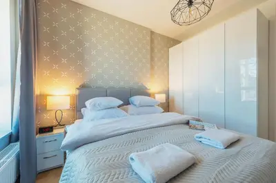 Łóżko lub łóżka w pokoju w obiekcie P&O Apartments KONSTRUKTORSKA Mokotów