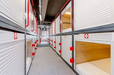 Łóżko lub łóżka piętrowe w pokoju w obiekcie Kapsuła Hostel Warszawa