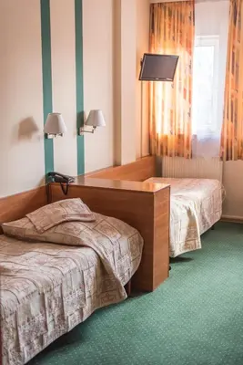 Łóżko lub łóżka w pokoju w obiekcie Amicus Żoliborz