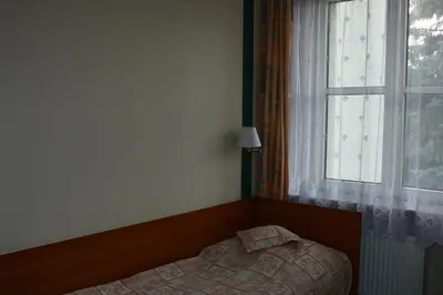 Łóżko lub łóżka w pokoju w obiekcie Amicus Żoliborz