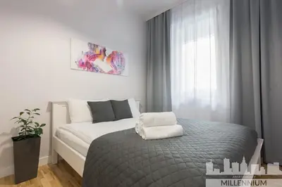 Łóżko lub łóżka w pokoju w obiekcie Millennium Awangarda Grey