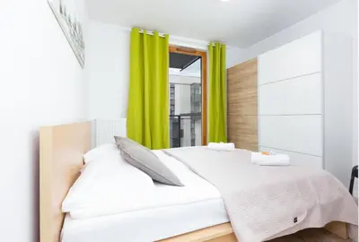 Łóżko lub łóżka w pokoju w obiekcie Apartamenty Kasprzaka P&O Serviced Apartments