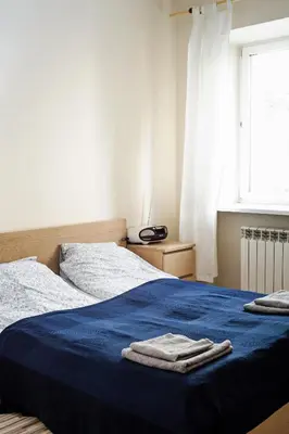 Łóżko lub łóżka w pokoju w obiekcie Marszałkowska Apartment