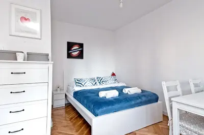 Łóżko lub łóżka w pokoju w obiekcie Noctis Apartment Pańska III