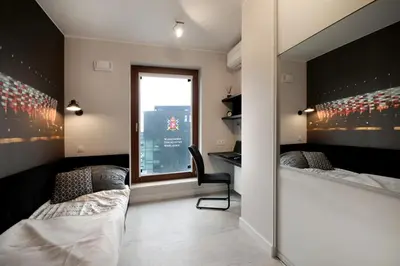 Łóżko lub łóżka w pokoju w obiekcie Bulwary Wislane P&O Serviced Apartments with AC