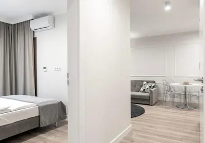 Łóżko lub łóżka w pokoju w obiekcie Mennica Residence