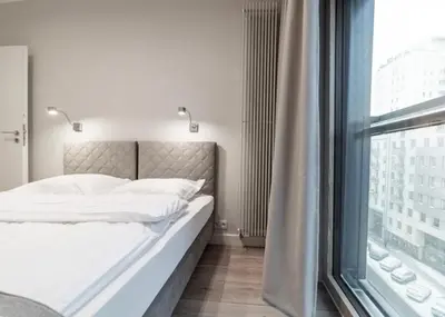 Łóżko lub łóżka w pokoju w obiekcie Mennica Residence