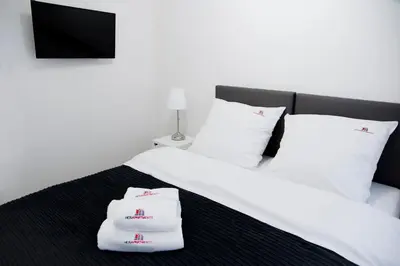 Łóżko lub łóżka w pokoju w obiekcie Hosapartments City Center