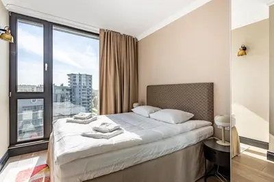 Łóżko lub łóżka w pokoju w obiekcie Triton Park Apartments