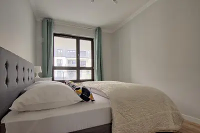 Łóżko lub łóżka w pokoju w obiekcie City Apartments Centrum