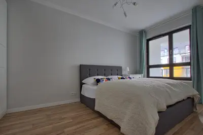 Łóżko lub łóżka w pokoju w obiekcie City Apartments Centrum
