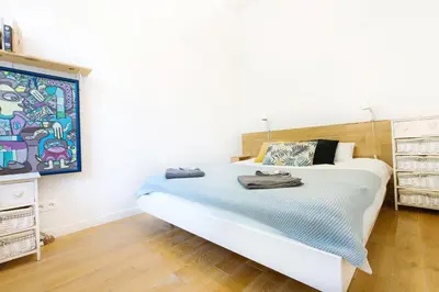 Łóżko lub łóżka w pokoju w obiekcie Warsaw Concierge Traveller's Nest Wspólna
