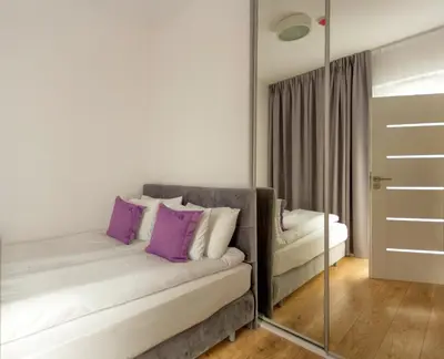 Łóżko lub łóżka w pokoju w obiekcie Apartamenty Vola Residence