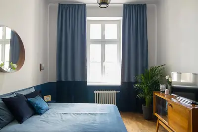 Łóżko lub łóżka w pokoju w obiekcie Aparthotel Nowy Świat 28