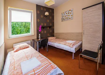 Łóżko lub łóżka w pokoju w obiekcie Hotelik Jankowski