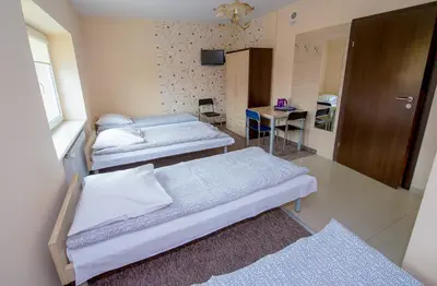 Łóżko lub łóżka w pokoju w obiekcie Hotelik Jankowski