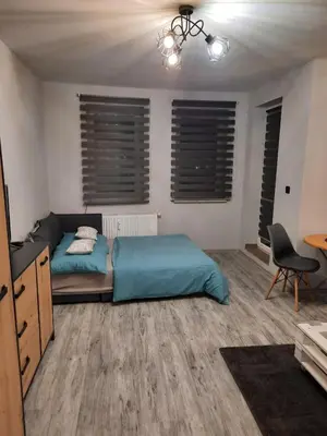 Łóżko lub łóżka w pokoju w obiekcie Apartamenty Trzy Wieze