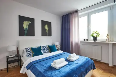 Łóżko lub łóżka w pokoju w obiekcie Noctis Apartment Plac Grzybowski