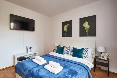Łóżko lub łóżka w pokoju w obiekcie Noctis Apartment Plac Grzybowski