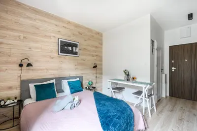 Łóżko lub łóżka w pokoju w obiekcie Aparthotel Pawia Deluxe- 10 min to center