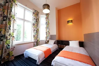 Łóżko lub łóżka w pokoju w obiekcie Planet Hostel
