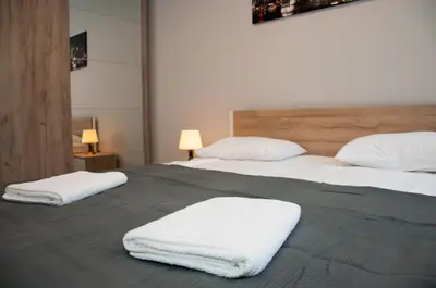 Łóżko lub łóżka w pokoju w obiekcie Apartament Cybernetyki Mokotów