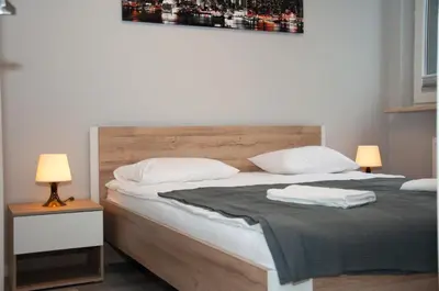Łóżko lub łóżka w pokoju w obiekcie Apartament Cybernetyki Mokotów