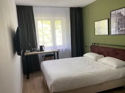Łóżko lub łóżka w pokoju w obiekcie Campanile Warszawa Północ