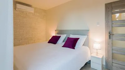 Łóżko lub łóżka w pokoju w obiekcie Aparthotel Koroni Home