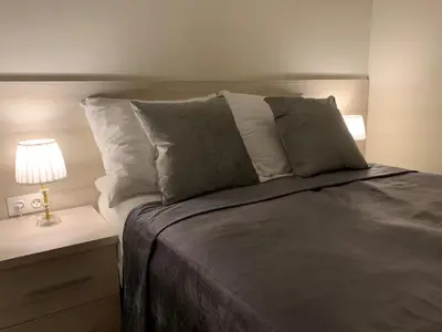 Łóżko lub łóżka w pokoju w obiekcie Aparthotel Koroni Home