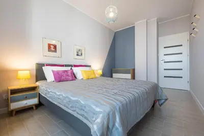 Łóżko lub łóżka w pokoju w obiekcie Raya Mansion Warsaw