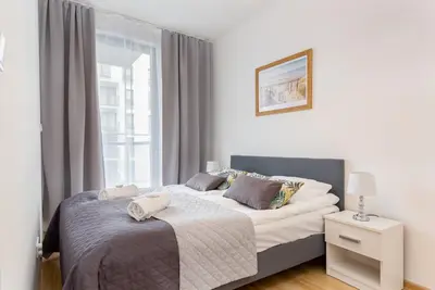 Łóżko lub łóżka w pokoju w obiekcie Apartments Varsovia Kasprzaka by Noclegi Renters