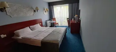 Łóżko lub łóżka w pokoju w obiekcie Amigo Hotel