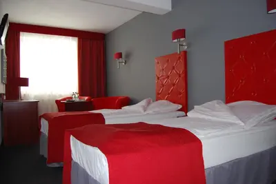 Łóżko lub łóżka w pokoju w obiekcie Amigo Hotel